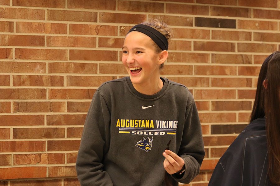 Lucy Westemeyer 21 laughs after cutting a strand of Anna Moore 21s hair after school on Friday, Jan. 11.