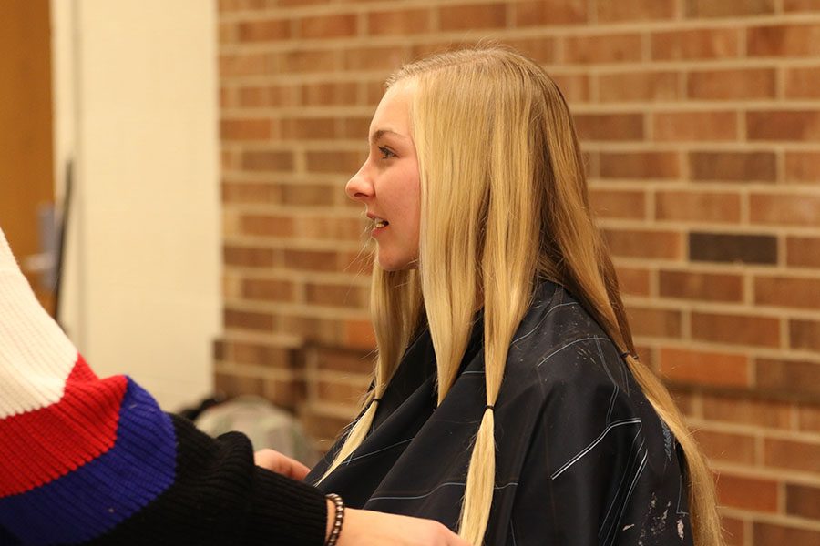 Katie Hoefer '21 gets her hair put into ponytails in order to donate eight inches on Friday, Jan. 11.