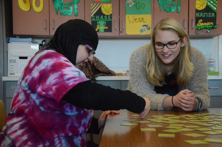 Laurel Haverkamp 20 plays a matching card game with a Buddies member.