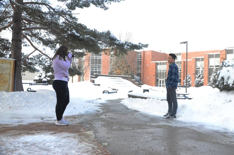 WSS photographer, Alyssa Skala 21, takes photos of George Liu 19 during the Portrait Service Project, a session aimed at providing senior pictures to those that still need them.