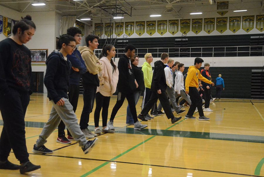 Students take a step forward during the Privilege Walk, a session aimed at visually portraying disparities in opportunities and advantages of varying backgrounds.
