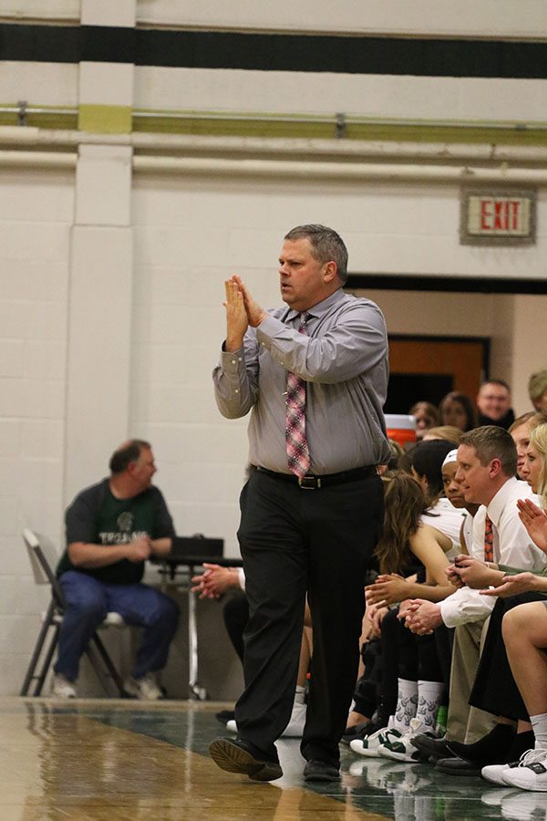 Head coach BJ Mayer claps during the first half of the game after West forced a turnover on Saturday, Feb. 16.