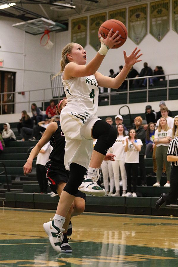 Lauren Zacharias 19 jumps up to make a layup during the second half. Zacharias scored seven points during the game on Saturday, Feb. 16.