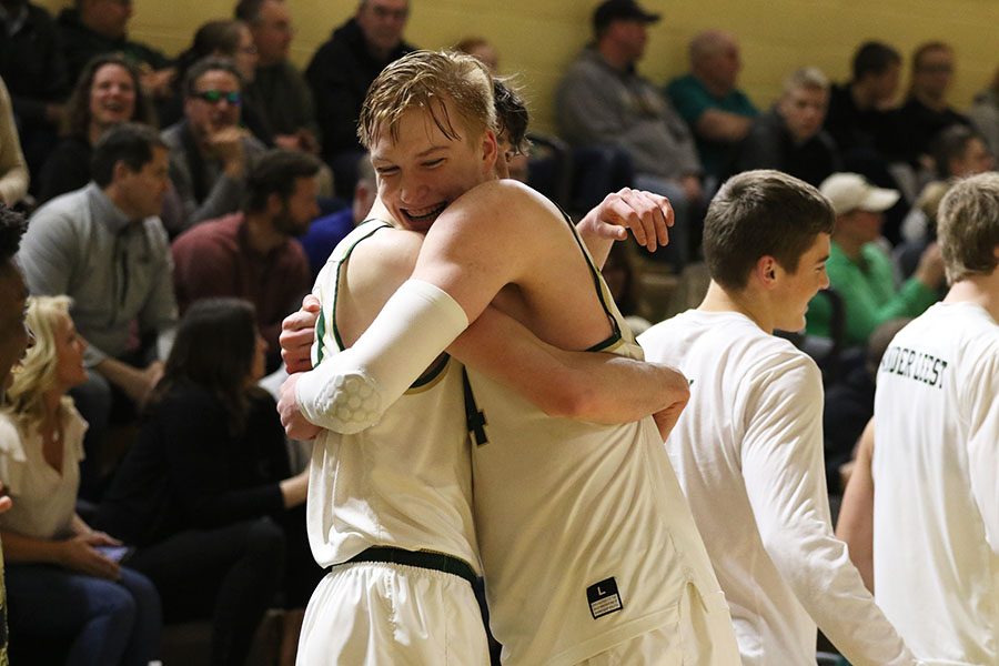 Even Brauns 20 hugs Patrick McCaffery 19 after they secured their win against Davenport Central on Tuesday, Feb. 26.