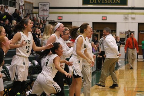 The girls basketball team cheers after Lauren Zacharias 19 scored the game-winning shot against Prairie on Friday, Nov. 30. 