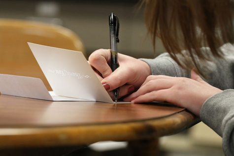 Sophie Stephens 19 poses as she writes a letter on Wednesday, Feb. 13.