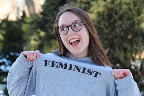 Photo Editor Maddi Shinall 19 poses for a photo as she displays her feminist slogan sweatshirt on Friday, Feb. 15.