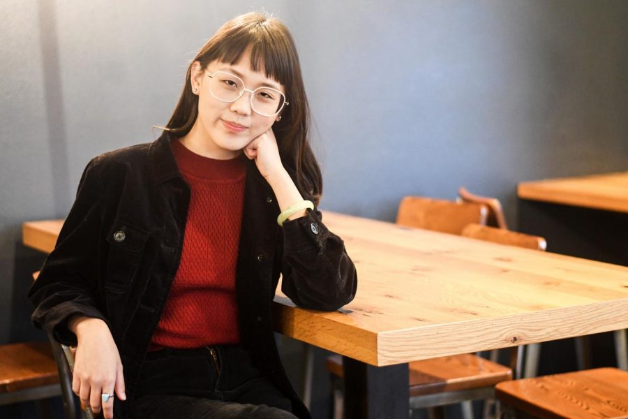 Shirley Wang poses for a photo at Java House. The 22-year-old was the creator of a viral podcast that detailed her fathers friendship with former NBA superstar Charles Barkley.