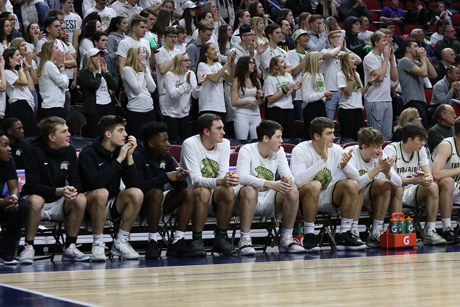 The student section and the bench cheer during the fourth quarter on Wednesday, March 6.