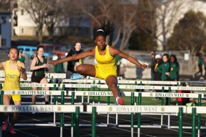 Matayia Tellis 21 sprints down the track during the JV 100 meter hurdle race on Tuesday, March 26. 