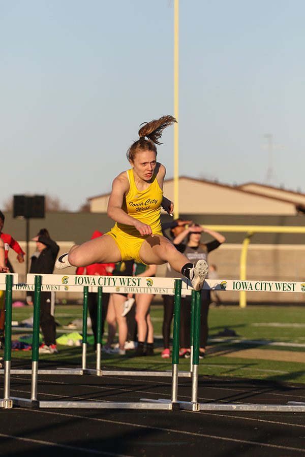 Peyton Steva 19 jumps over the last hurdle of the 100 meter hurdle race. Steva won the race with a time of 15.15. 