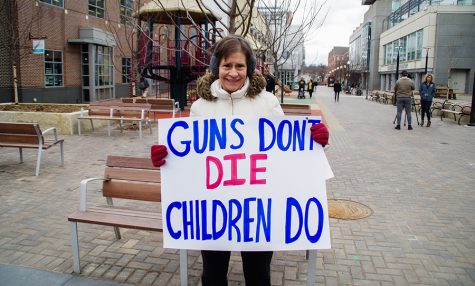 Local resident, Lonni Parrot, shows her support for the victims of gun violence.