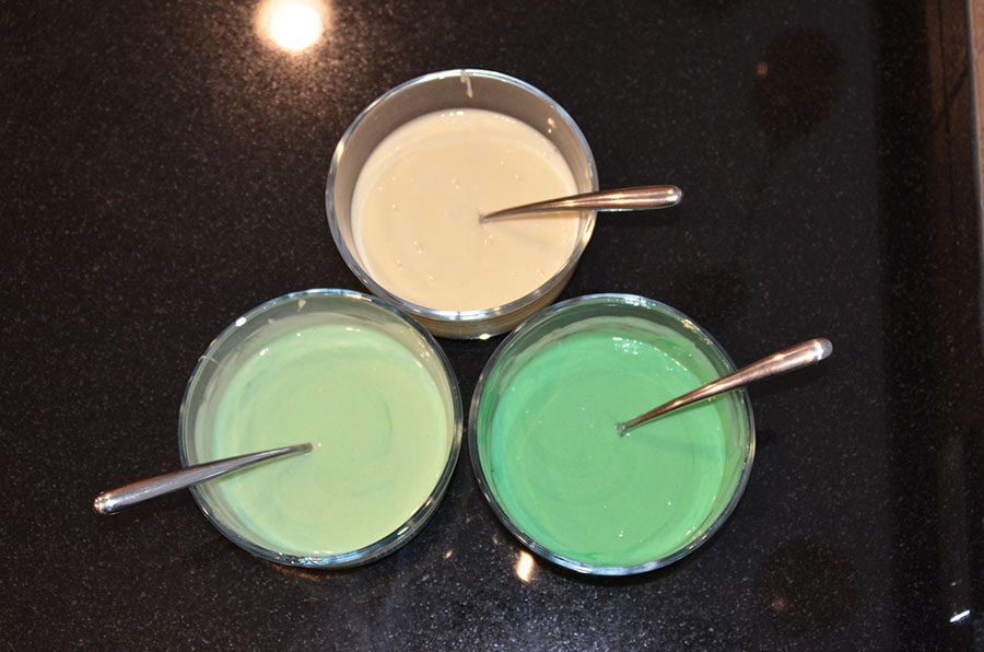 The more green food coloring used, the darker the shade will be. Make sure to leave one bowl without any food coloring. 