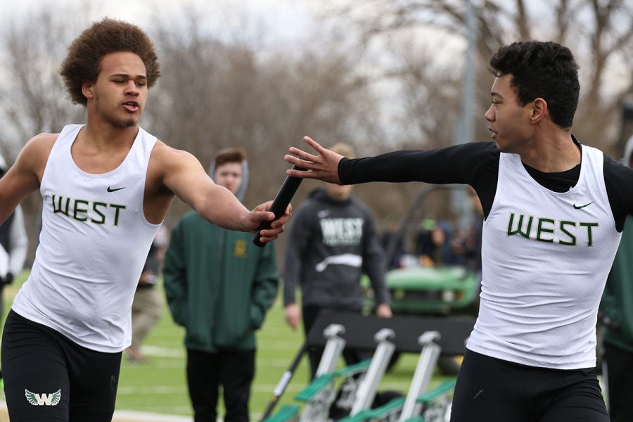 Mekhi Johnson 20 hands the baton off to Chris Caruthers 20, the third runner during the 4x200 meter relay on Saturday, April 13. The Trojans placed seventh in 1:45.99.