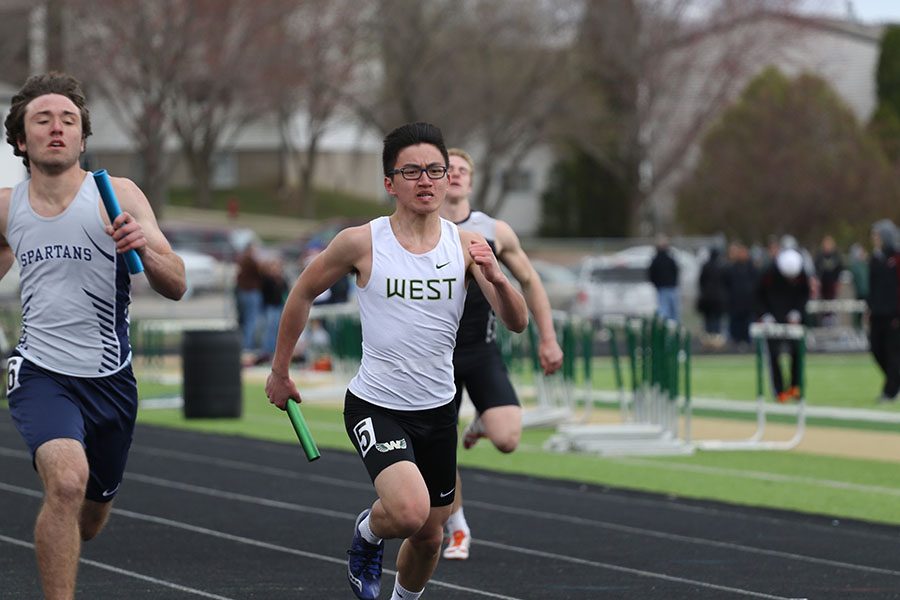 Jason Lu 21 sprints down the last 50 meters on the track during the 4x200 meter relay on Saturday, April 13.