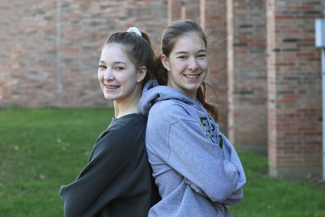 Twins Lizzy and Makayla Slade 21 stand side by side before school for a photo on Friday, April 19.