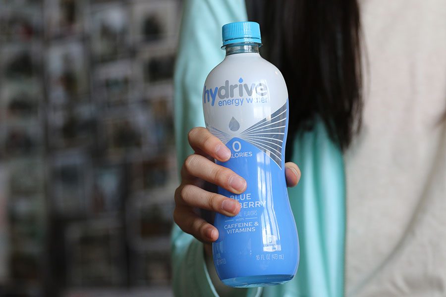 Lily Meng 19 holds a bottle of caffeinated water called Hydrive. This water can be bought at West.  