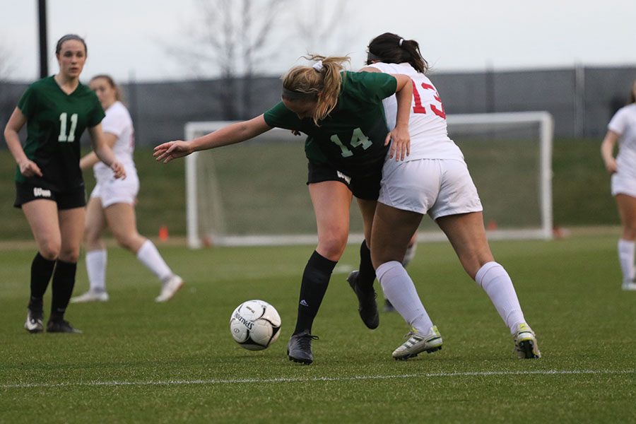 Kennedy Hochstedler 19 battles to get the ball back as City Highs Rocxana Carrera 19 kicks it away from her on Tuesday, April 9.