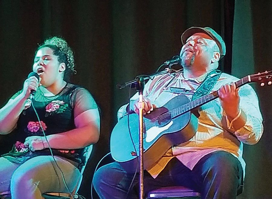 Phoebe Burt ‘21 and her father Kevin Burt sing and play “Lean On Me” by Bill Withers at Wildwood Saloon in North Liberty earlier this year. 