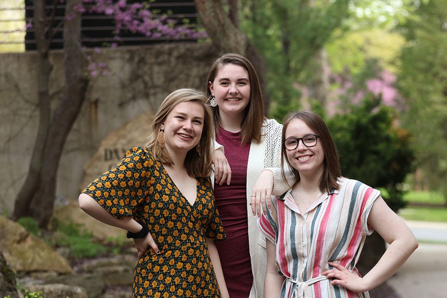 Seniors Lucy Polyak, Sophie Stephens and Maddi Shinall stand together wearing their fancy attire downtown Iowa City on Sunday, May 5.