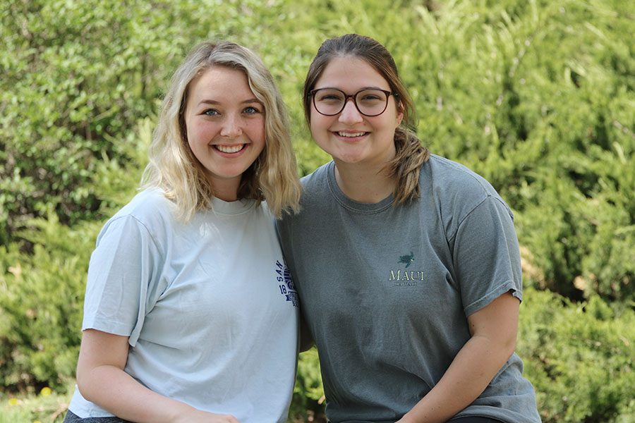 Seniors Olivia Dachtler and Maddy Luegering pose for a photo during lunch in the courtyard on Monday, May 6.