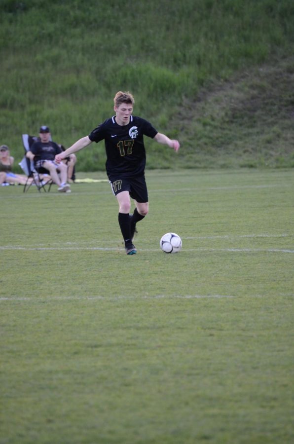 Luke Moenning '21 plays the ball up field, trying to make it easier for his teammates to score.