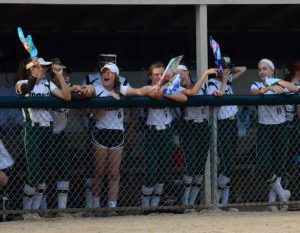 West High softball players cheer on Ryleigh Mulcahey 19 from the dugout on her senior night in a game against Cedar Rapids Washington on June 25.