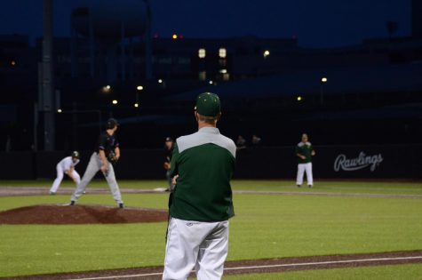 Head coach Charlie Stumpff observes the game from his position as third base coach during a game against Liberty on June 3.