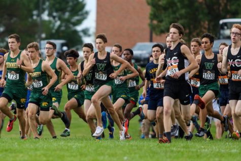 Alex McKane 22 and the Trojans sprint out of the starting line during the Prairie Invitational at Prairie High School on Aug. 31.
