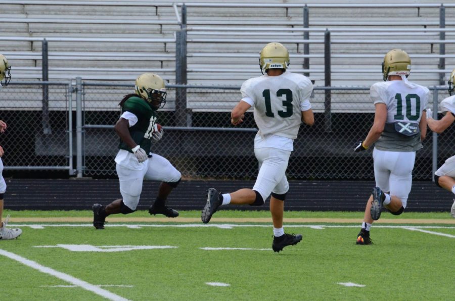 Running back Marchaun Hoover '20 runs the ball during the Green and Gold Scrimmage at West High on August 17. 