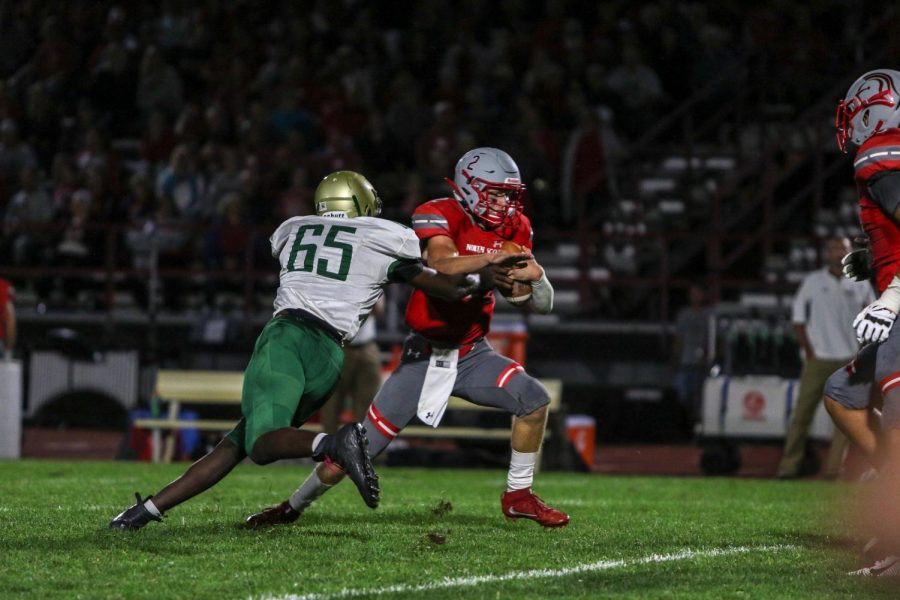 Anu Dokum '20 reaches for a sack during a game against North Scott on Aug. 30.