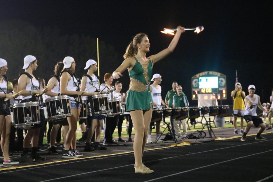 Lizzy Slade 21 showing off as she tosses her fire baton into the air for the crowd.