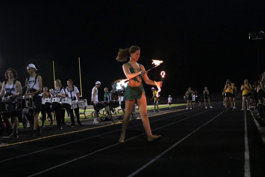 Lizzy Slade 21 lighting a second fire baton preparing to wow the student section.