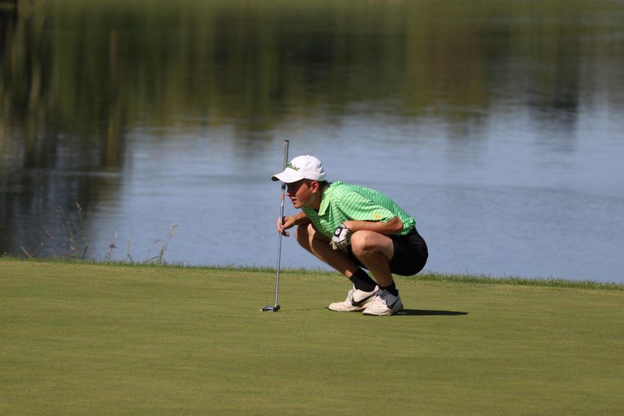 Andrew Tauchen 21 reads the green before a putt on the 13th hole during a home meet at Finkbine Golf Course in 2018.
