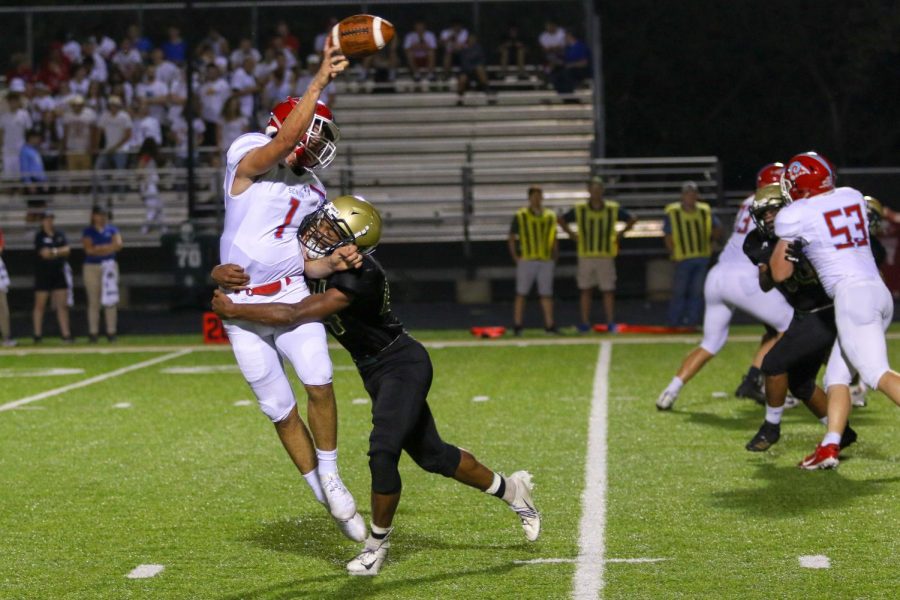 Mason Applegate '22 pressures the Dubuque Senior quarterback during the team's game against Dubuque Senior at Trojan Field on Sept. 20.