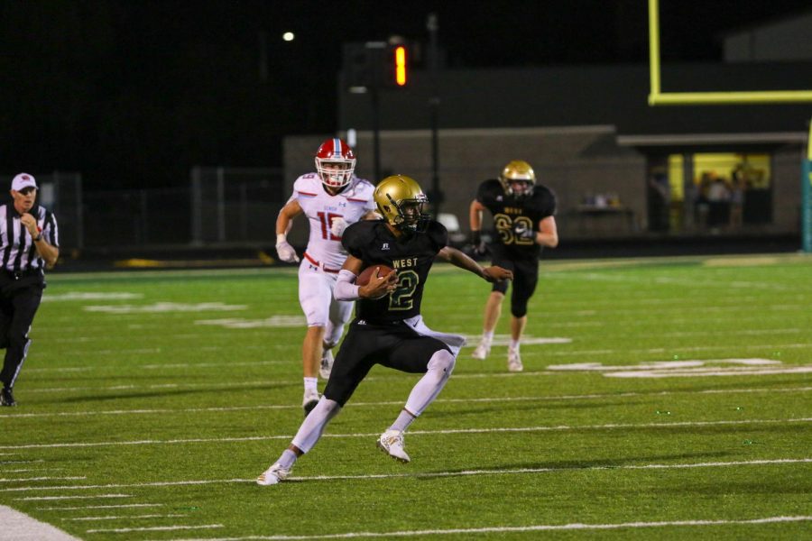 Marcus Morgan '21 makes a cut avoiding Ram defenders on Sept. 20 during the game at Trojan Field.