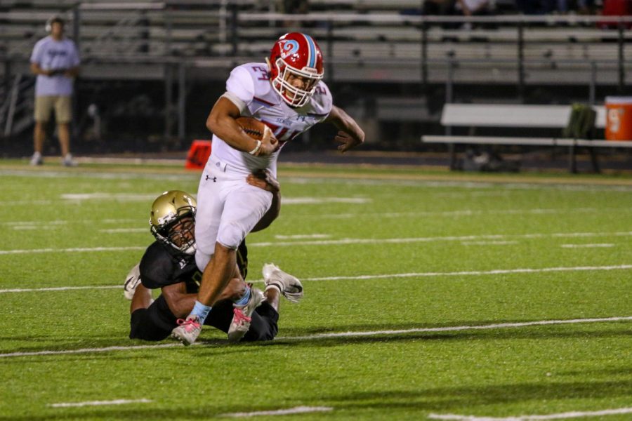 Mason Applegate '22 trips up the Ram running back on Sept. 20 during the game at Trojan Field.