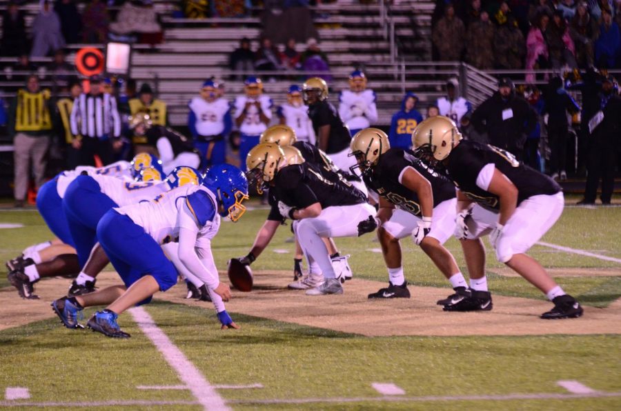 The offensive line sets up before a crucial third down play against Davenport North on Oct. 11 at Trojan Field.