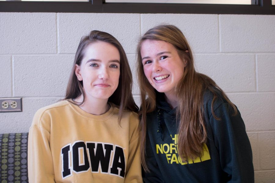 Mia Dillingham 20 and Mary Woodward 21 pose for a photo in the library.