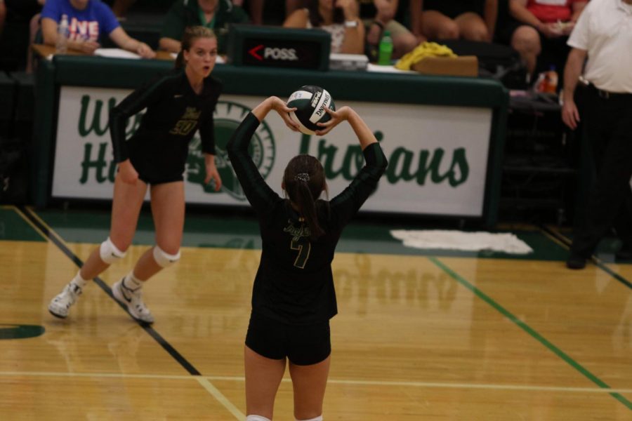 Emma Dunlap '22 sets the ball for her hitter during the Battle for the Spike at West High on Aug. 27.