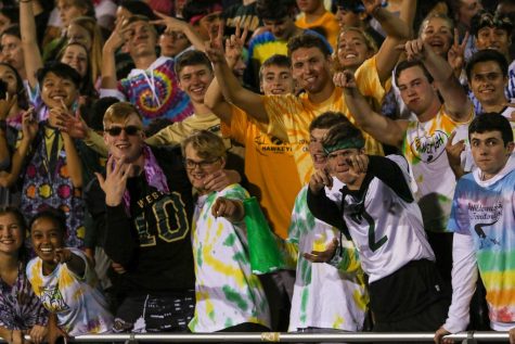 James Pinter 20 and members of the student section pose for a pictures as they cheer on the Trojans against Bettendorf on Sept. 6.