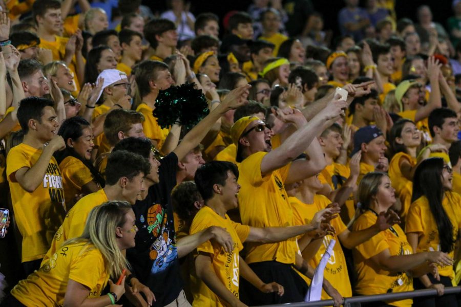 Even Brauns '20 and the student section get hyped during the halftime drumline performance at the Gold Out football game against Dubuque Senior on Sept. 20.   