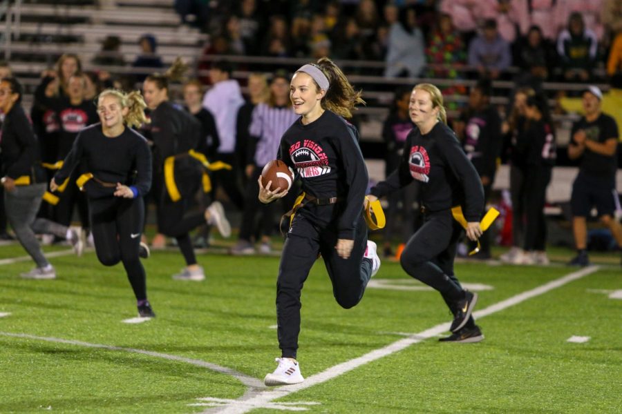 Eva Burbidge '20 carries the ball for a touchdown during West High's annual powderpuff game on Oct. 3rd. 