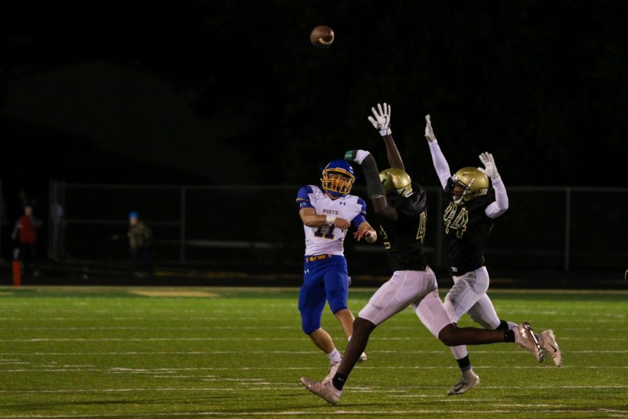 Defensive linemen Anu Dokun '20 and Mason Applegate '22 being pressure onto the Wildcat quarterback during the team's game against Davenport North at Trojan Field on Oct. 11. 