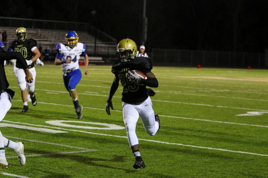 Fabian Brown '21 makes his way to the end zone against Davenport North at Trojan Field on Oct. 11. Brown scored on the play, giving the Trojans their first lead of the game.