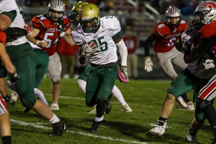 Fabian Brown '21 finds a crease in the City High defense for a first down in the second quarter of the Battle for the Boot at Bates Field on Oct. 25.