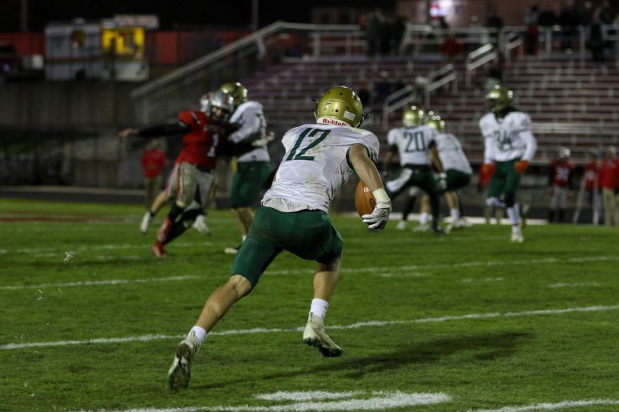 Grahm Goering '21 hits full stride during his 79-yard kickoff return for a touchdown in the third quarter of the Battle for the Boot at Bates Field on Oct. 25.