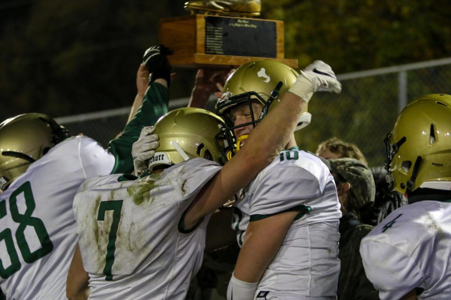 Grant Henderson '20 and Tate Crane '20 embrace while celebrating with the student section following the team's 36-32 victory in the Battle for the Boot on Oct. 25.