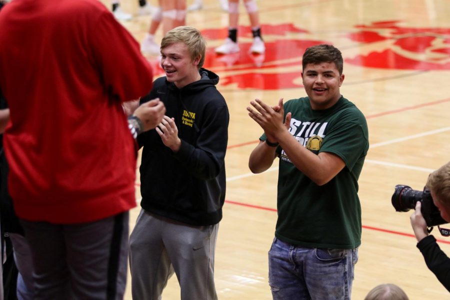 Senior football players Grant Henderson and Makhi Halvorsen lead the student section in the 'West High rumble' at the team's volleyball playoff match against City on Oct. 29.