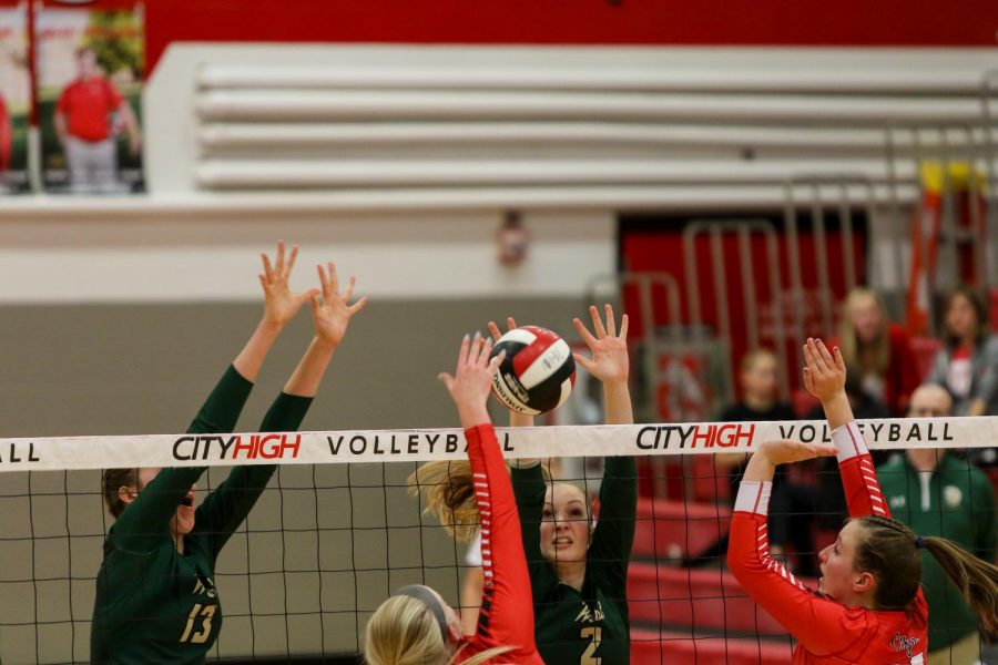 Misha Canin '22 and Natalie Young '20 close in on a block at the team's volleyball playoff match against City on Oct. 29.